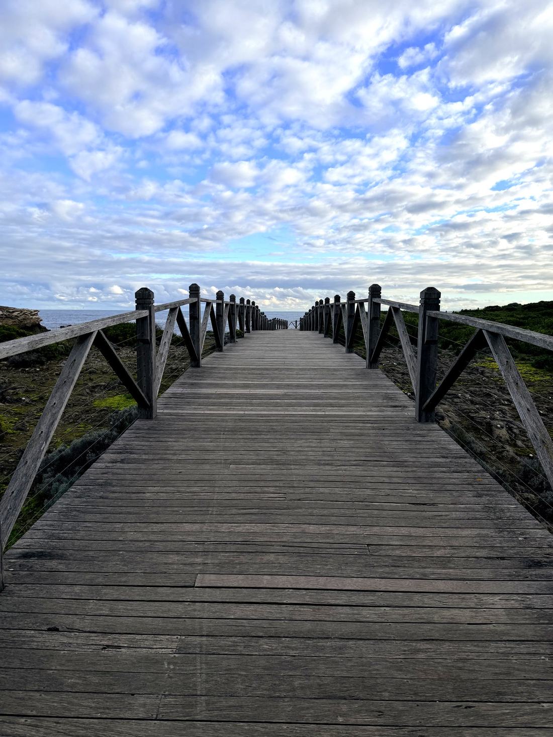 A boardwalk leading toward the sea